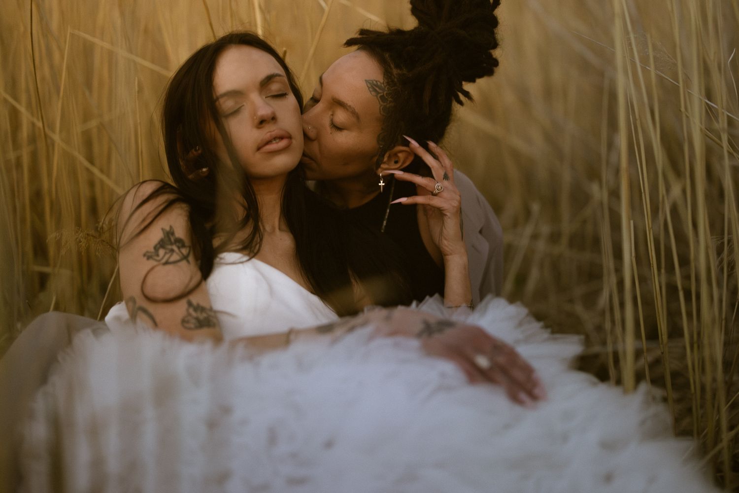 Couple embracing in a golden Utah field, by Sammy Aucella Photography