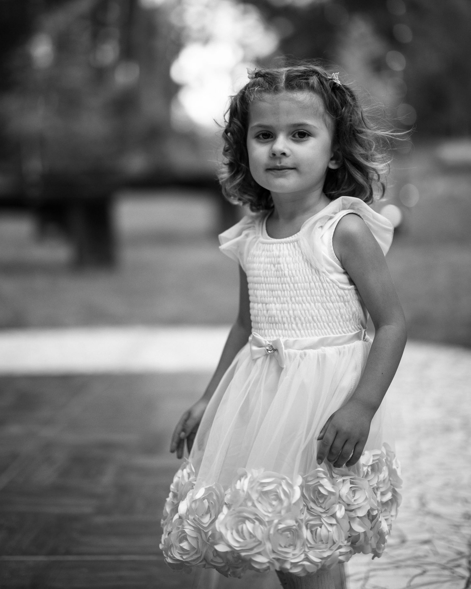 Black and white portrait of the flower girl at a Hartwood wedding in Mendocino, California, by Sammy Aucella Photography