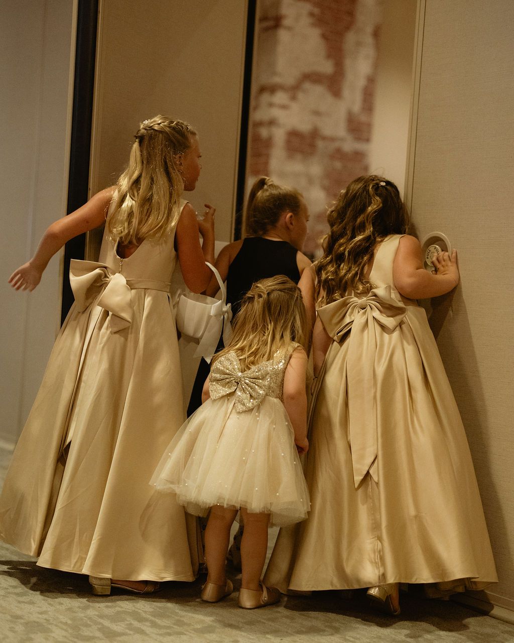 Bride with her flower girls in gold dresses at a Whitney Peak Hotel wedding in Reno, Nevada, by Sammy Aucella Photography