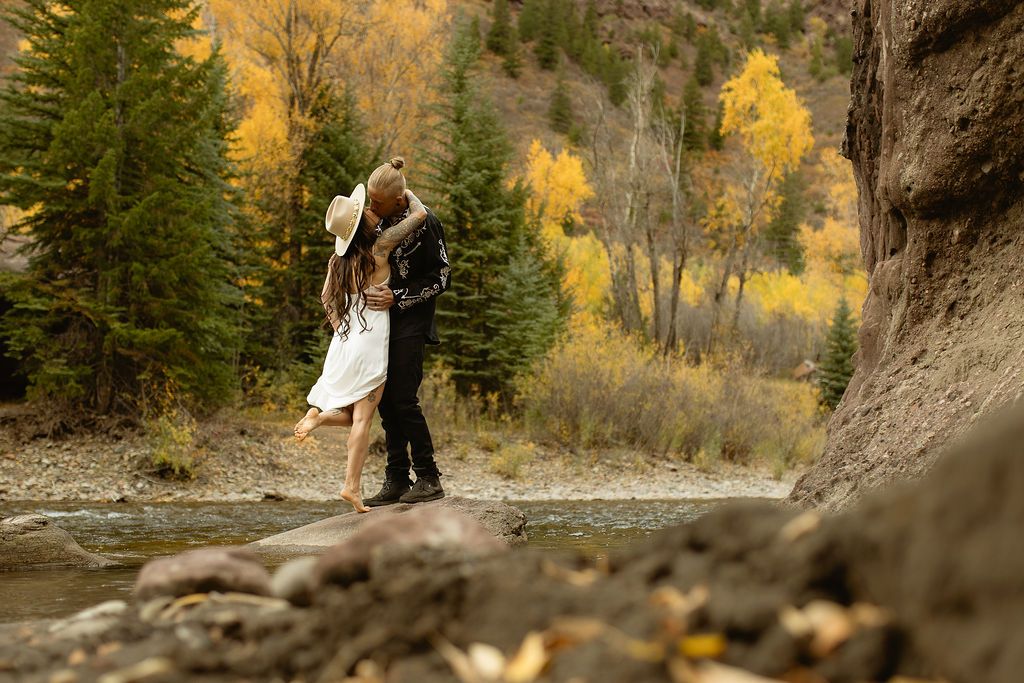 Couple embracing in a golden aspen forest, by Sammy Aucella Photography