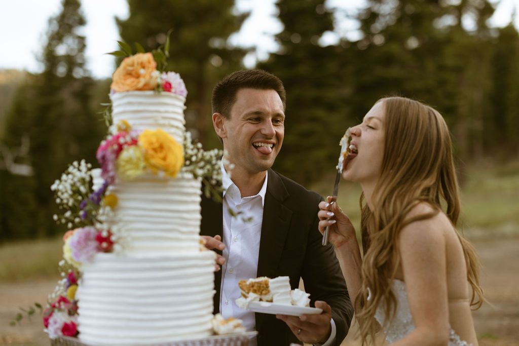 Bride and groom feeding each other cake at a Ritz-Carlton Lake Tahoe wedding, by Sammy Aucella Photography