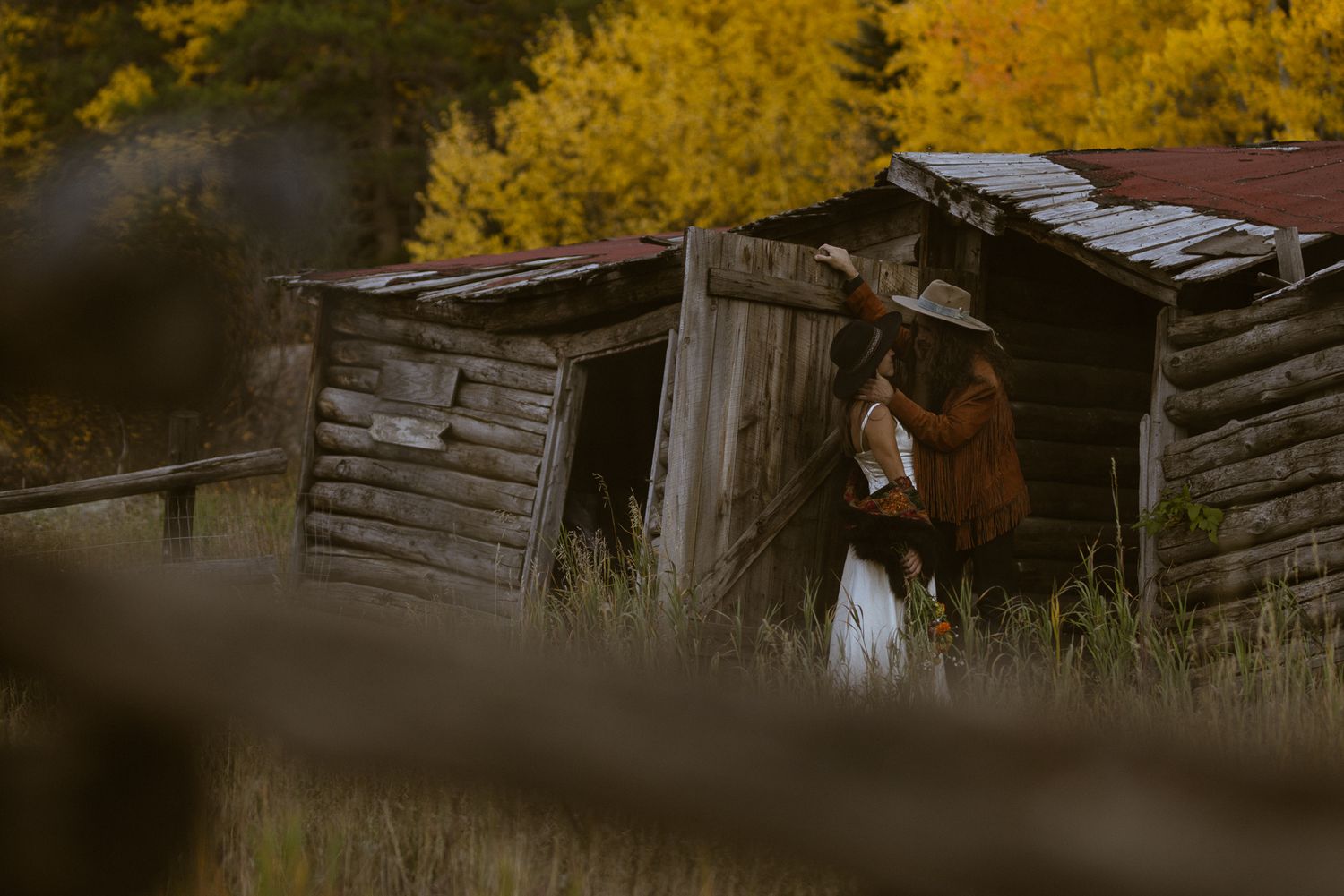 Couple beside a rustic desert cabin in Utah, by Sammy Aucella Photography