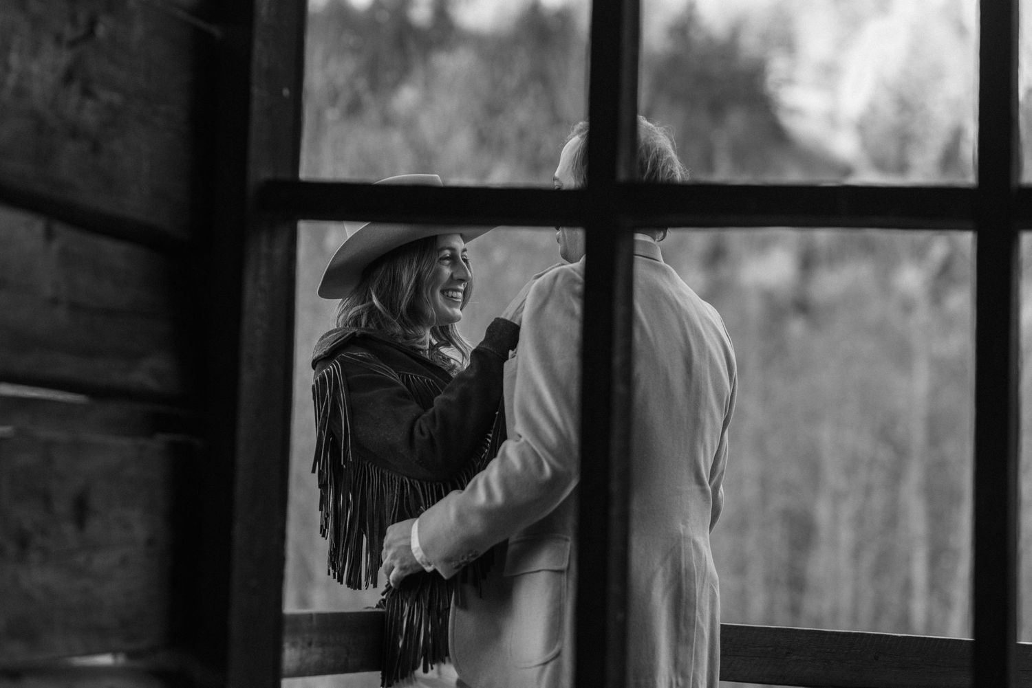 Woman in custom hat and fringe vintage western jacket at Ashcroft Ghost Town Aspen Colorado engagement session by Sammy Aucella Photography