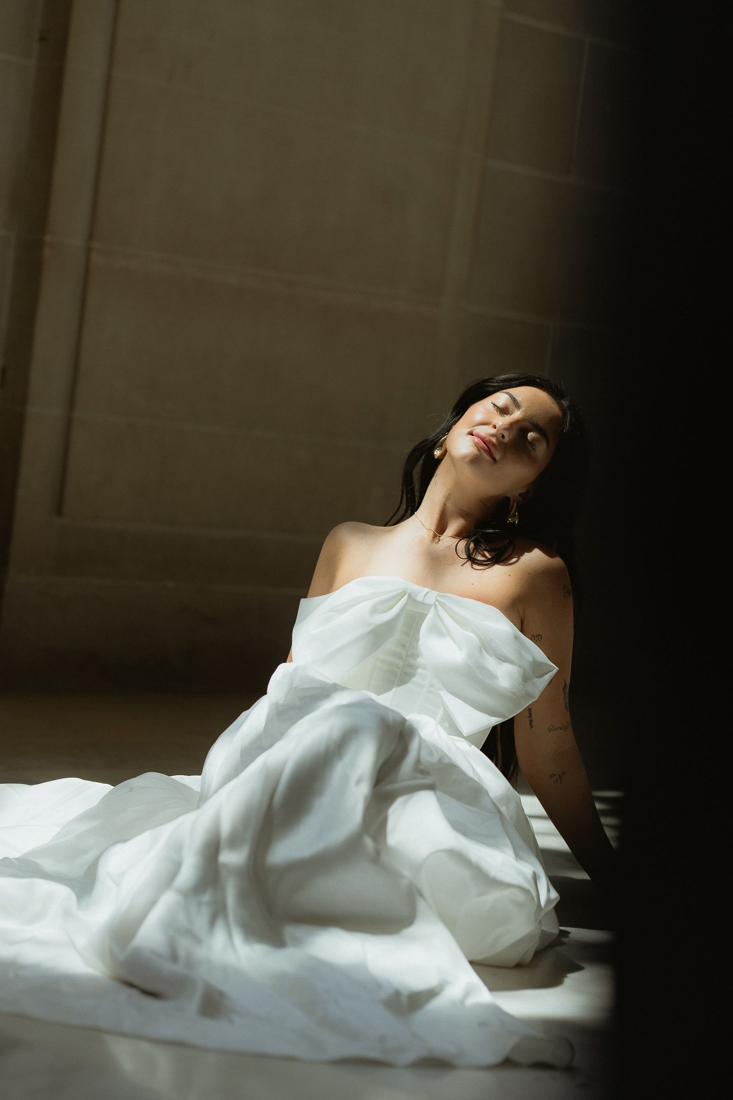 Bride leaning back in an off-shoulder gown at a San Francisco City Hall elopement, by Sammy Aucella Photography