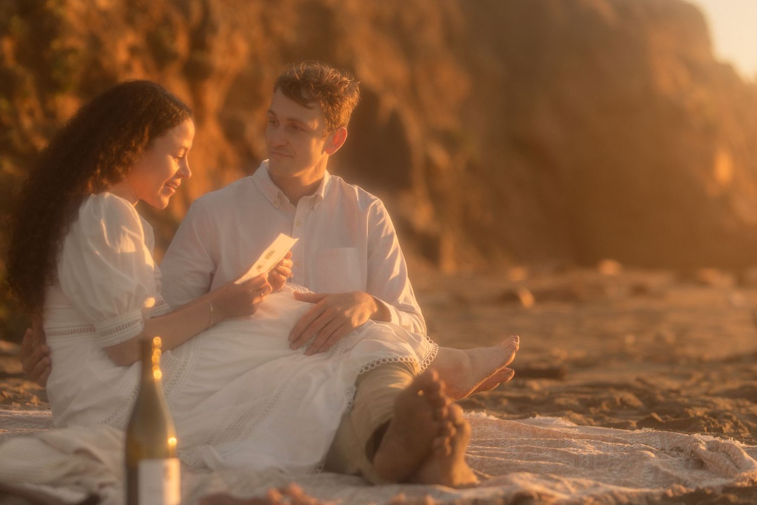 Couple sitting together on beach enjoying engagement session in Gualala California Mendocino CA by Sammy Aucella Photography