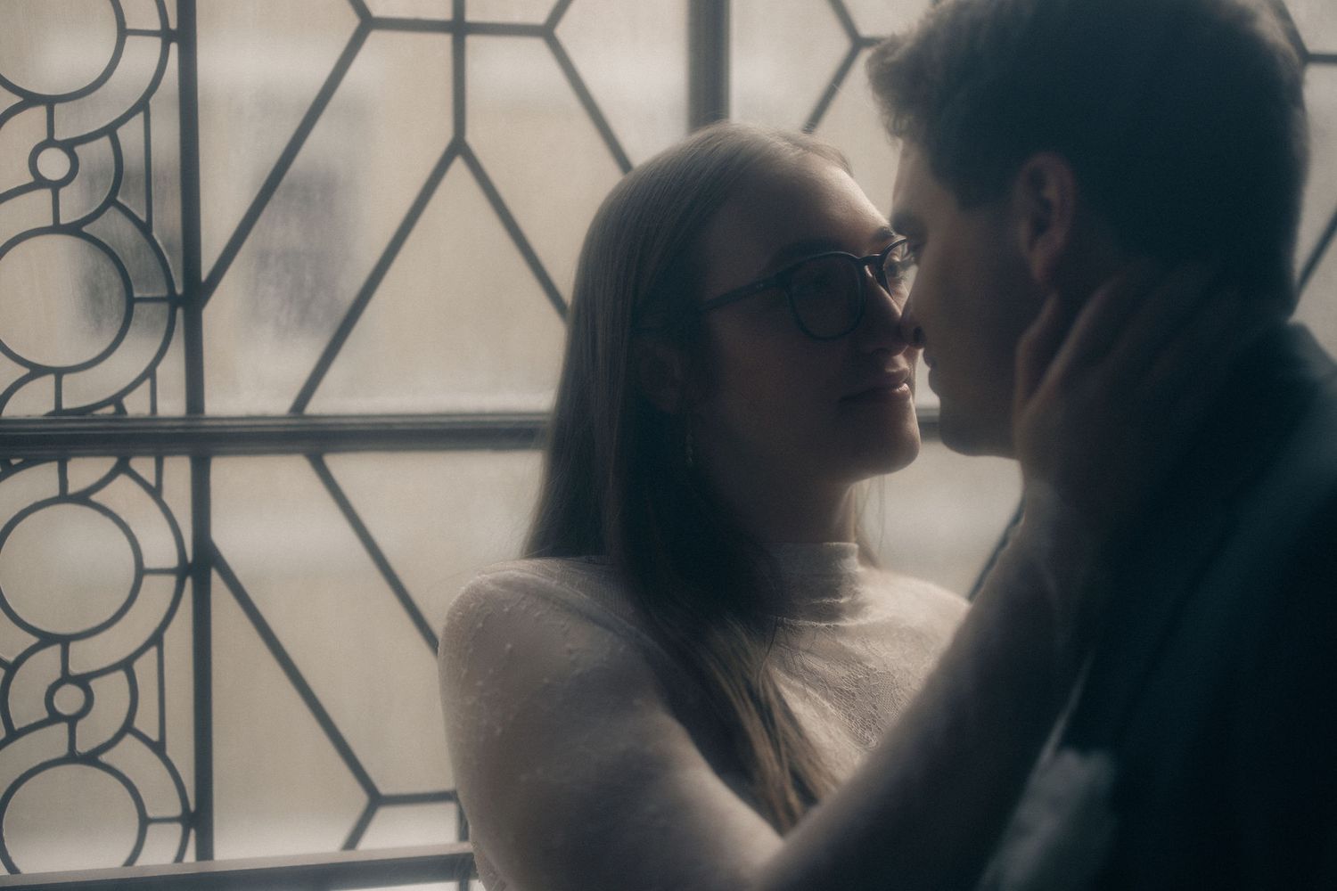 Couple kissing by a window at a San Francisco City Hall elopement, by Sammy Aucella Photography