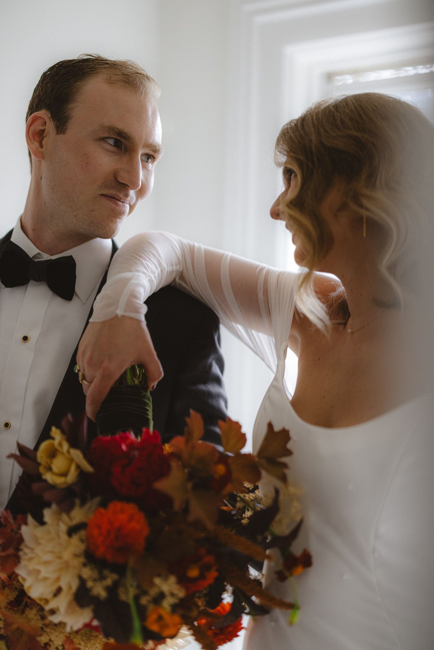Bride and groom cutting their cake with autumn florals at a Cuffey's Cove wedding in Elk, Mendocino, by Sammy Aucella Photography
