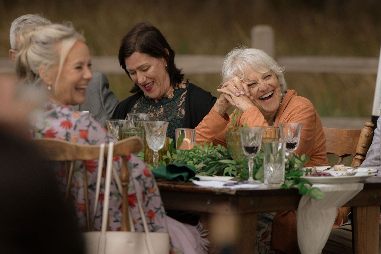 Guests laughing during the reception at a Spring Ranch wedding in Mendocino, California, by Sammy Aucella Photography