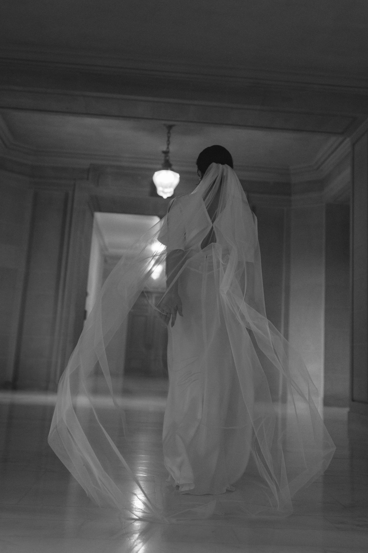 Bride with a flowing veil beneath the dome at a San Francisco City Hall elopement, by Sammy Aucella Photography