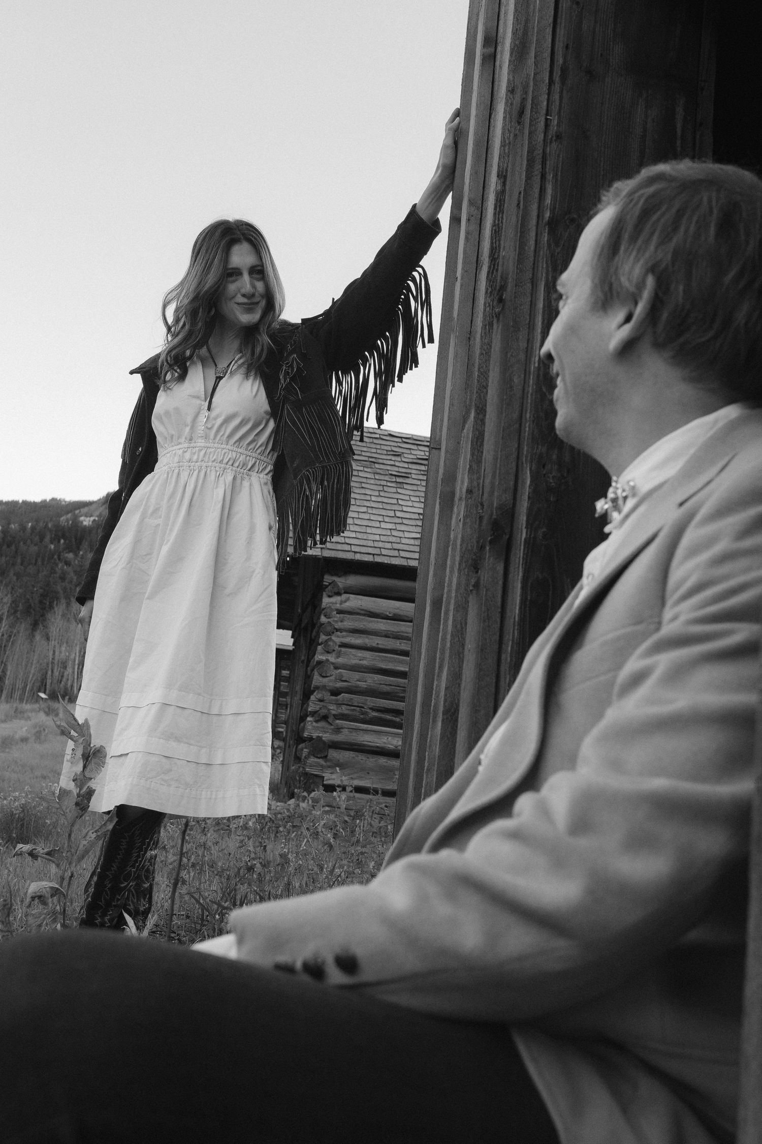 Woman in custom hat and fringe vintage western jacket at Ashcroft Ghost Town Aspen Colorado engagement session by Sammy Aucella Photography