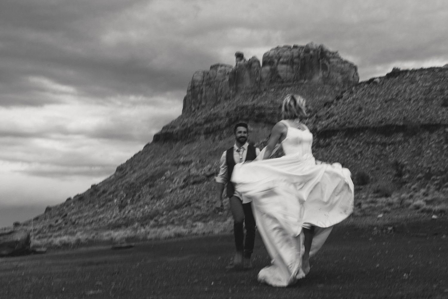 Black and white couple at the base of a Moab butte in Utah, by Sammy Aucella Photography