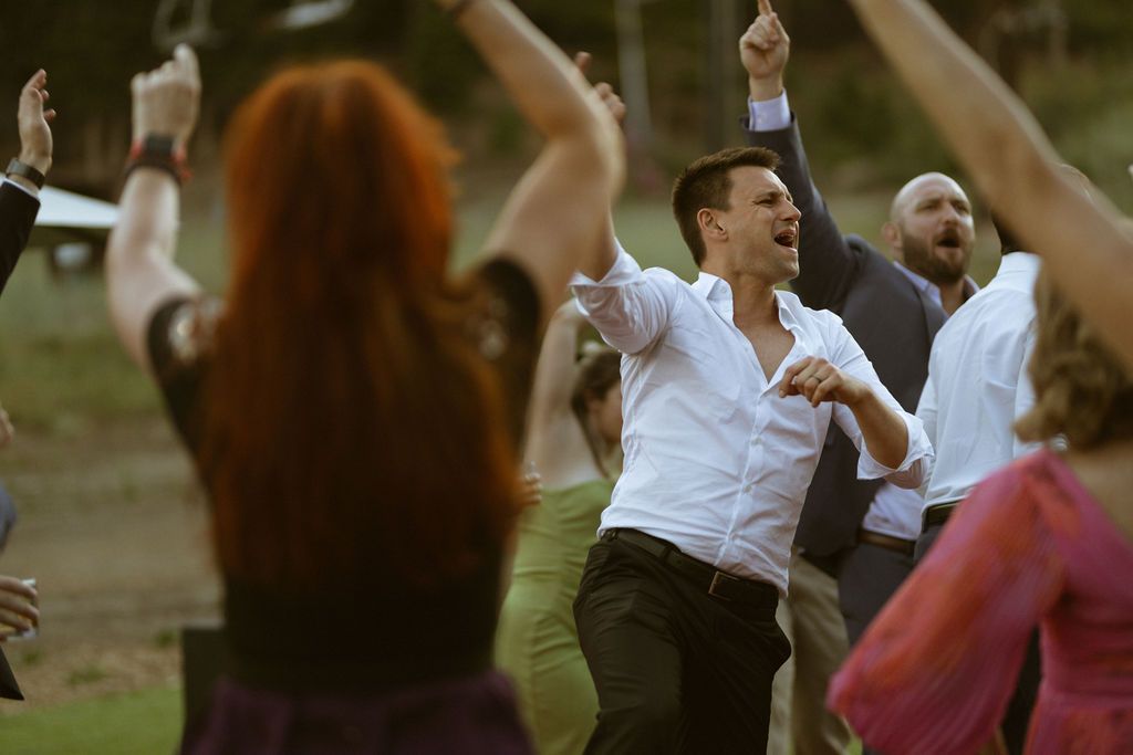 Groom dancing joyfully at the reception at a Ritz-Carlton Lake Tahoe wedding, by Sammy Aucella Photography
