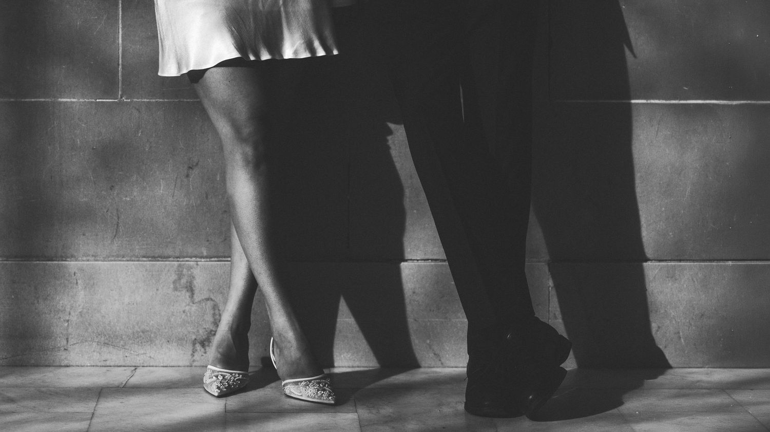 Couple's silhouettes and shadows in dramatic light at a San Francisco City Hall elopement, by Sammy Aucella Photography