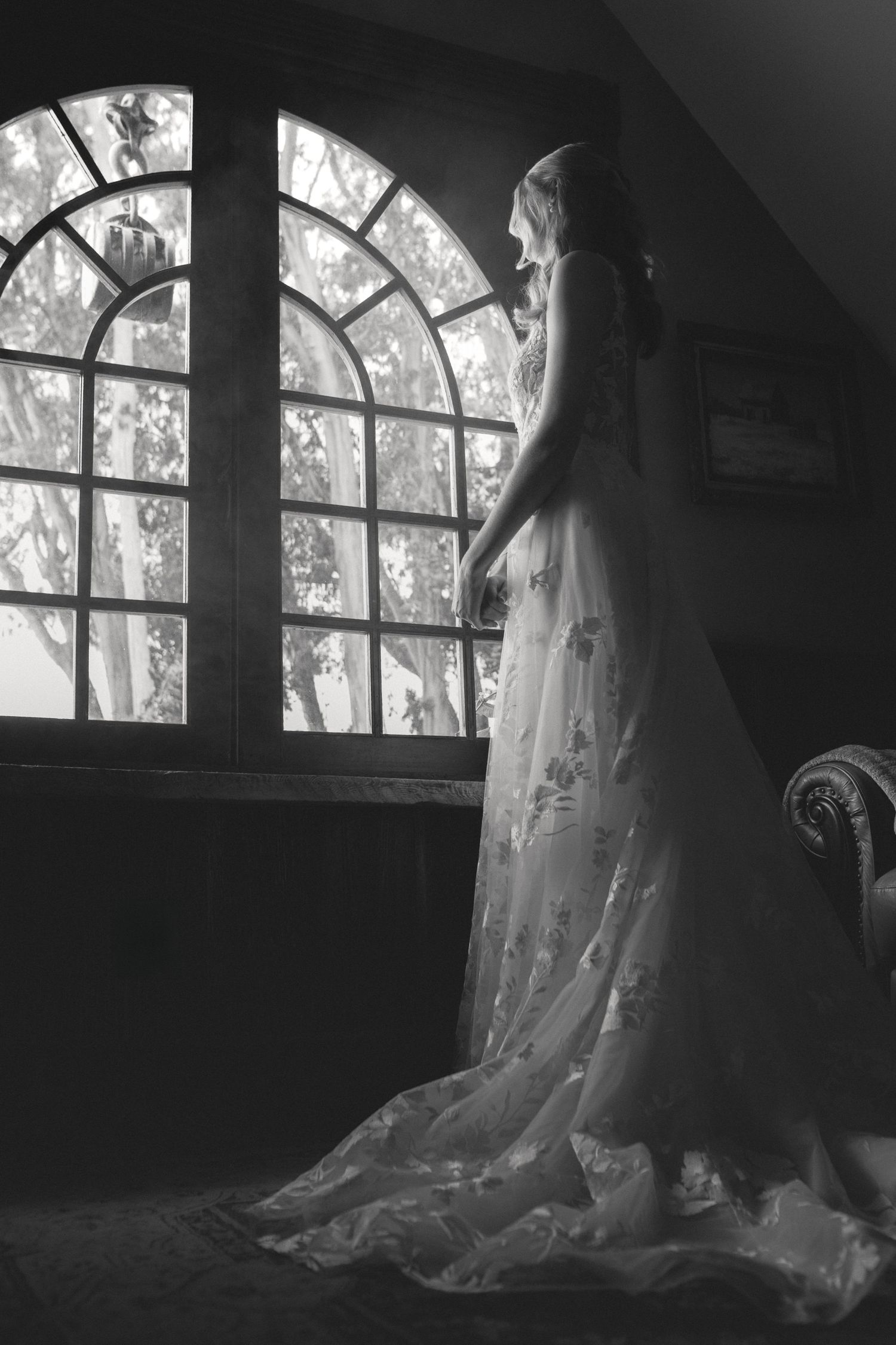 Bride and her veil framed by an arched window at a Spring Ranch wedding in Mendocino, California, by Sammy Aucella Photography