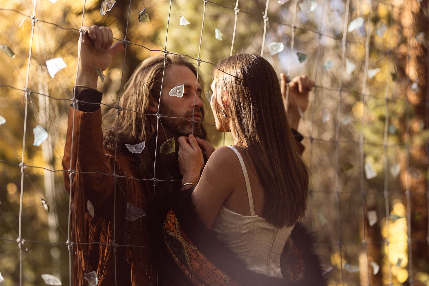 Two women laughing together in golden light at an adventure session, by Sammy Aucella Photography