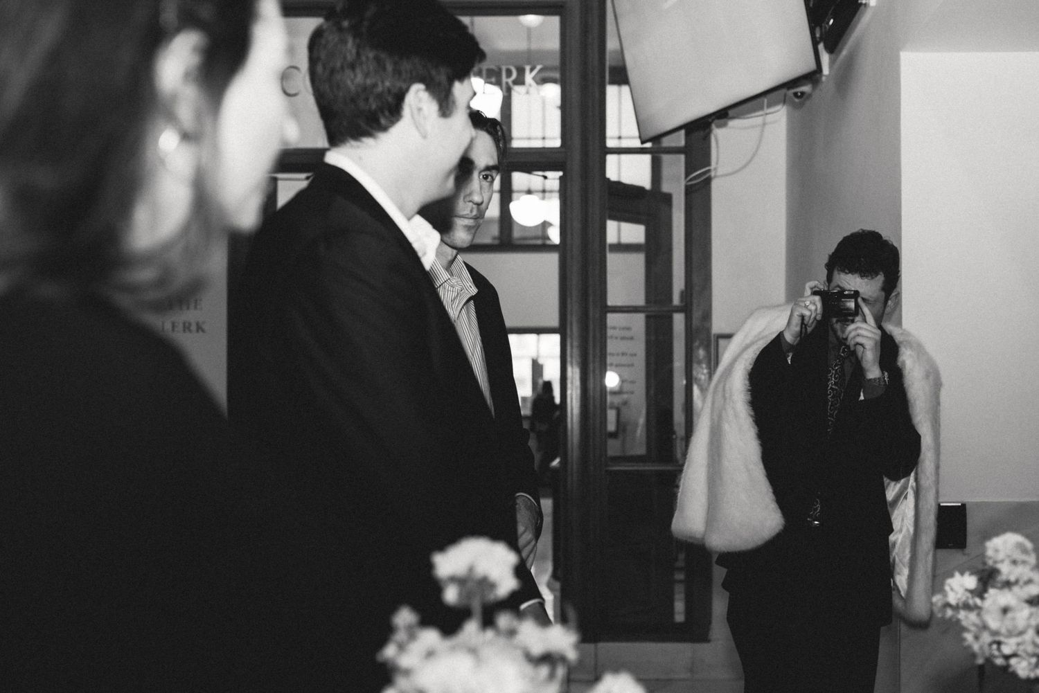 Candid moment with the groom and a guest at a San Francisco City Hall elopement, by Sammy Aucella Photography