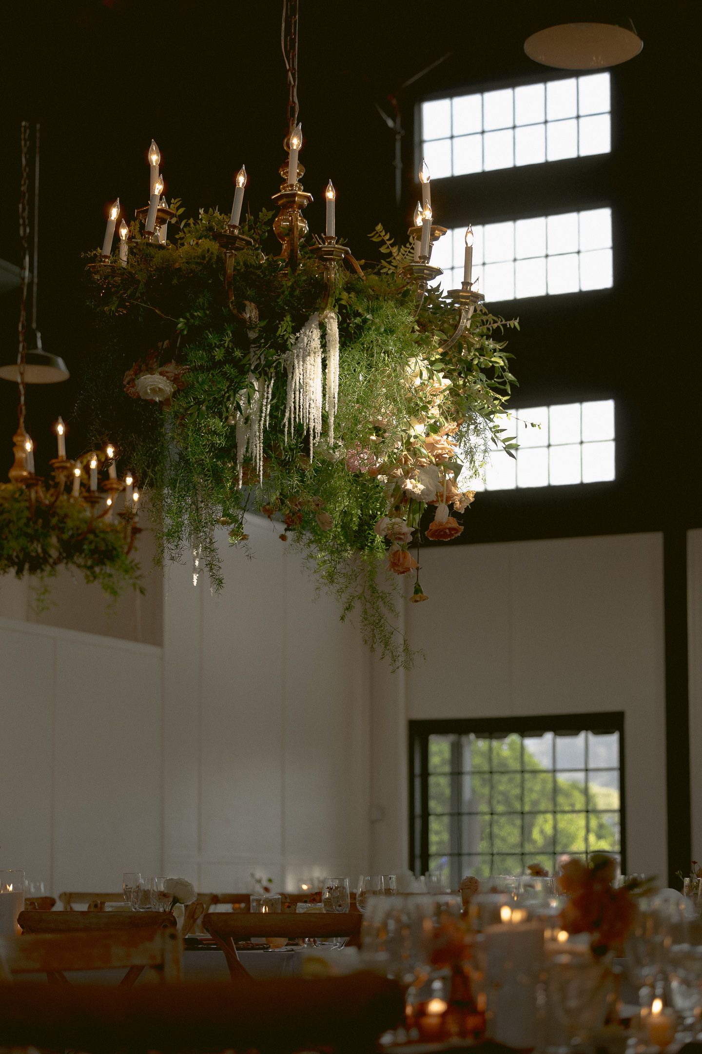 Hanging floral installation by the windows at a Mission Ranch wedding in Carmel, California, by Sammy Aucella Photography