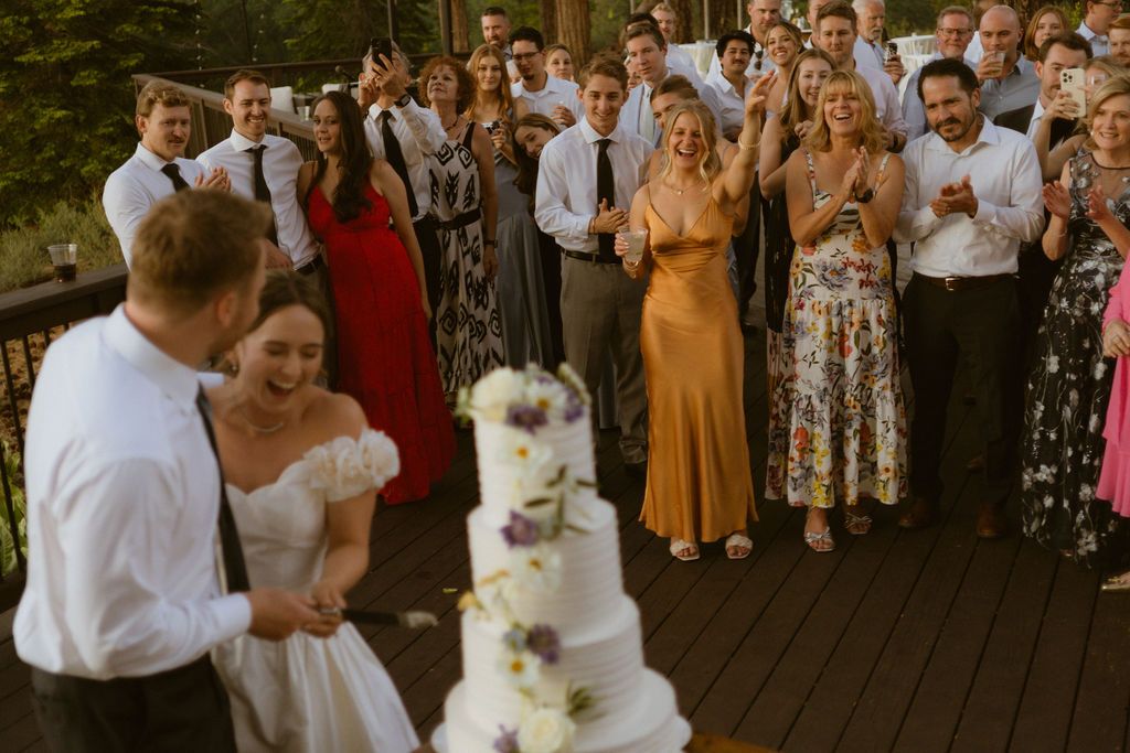 Newlyweds with guests and wedding cake at Nakoma Resort in Clio, California, by Sammy Aucella Photography