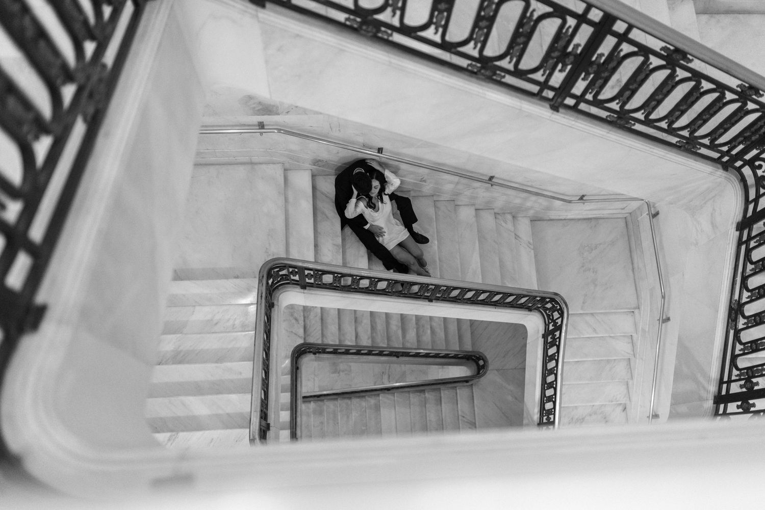 Black and white view of the grand marble staircase at a San Francisco City Hall elopement, by Sammy Aucella Photography