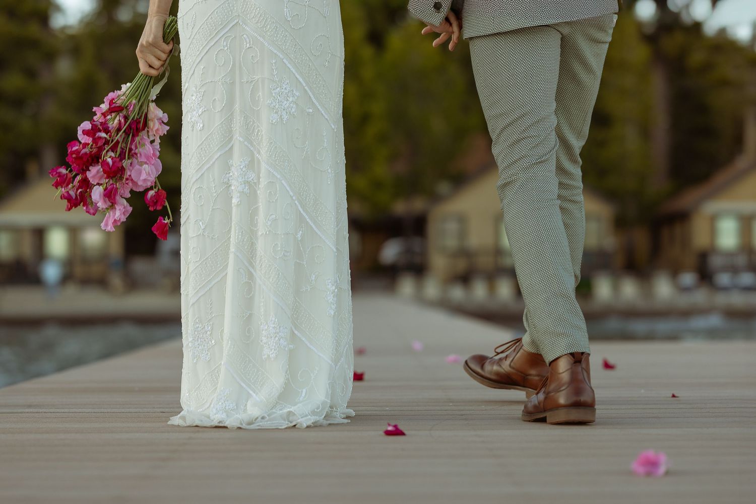 Bride walking the aisle over scattered petals at a Franciscan Lakeside Lodge Lake Tahoe wedding, by Sammy Aucella Photography