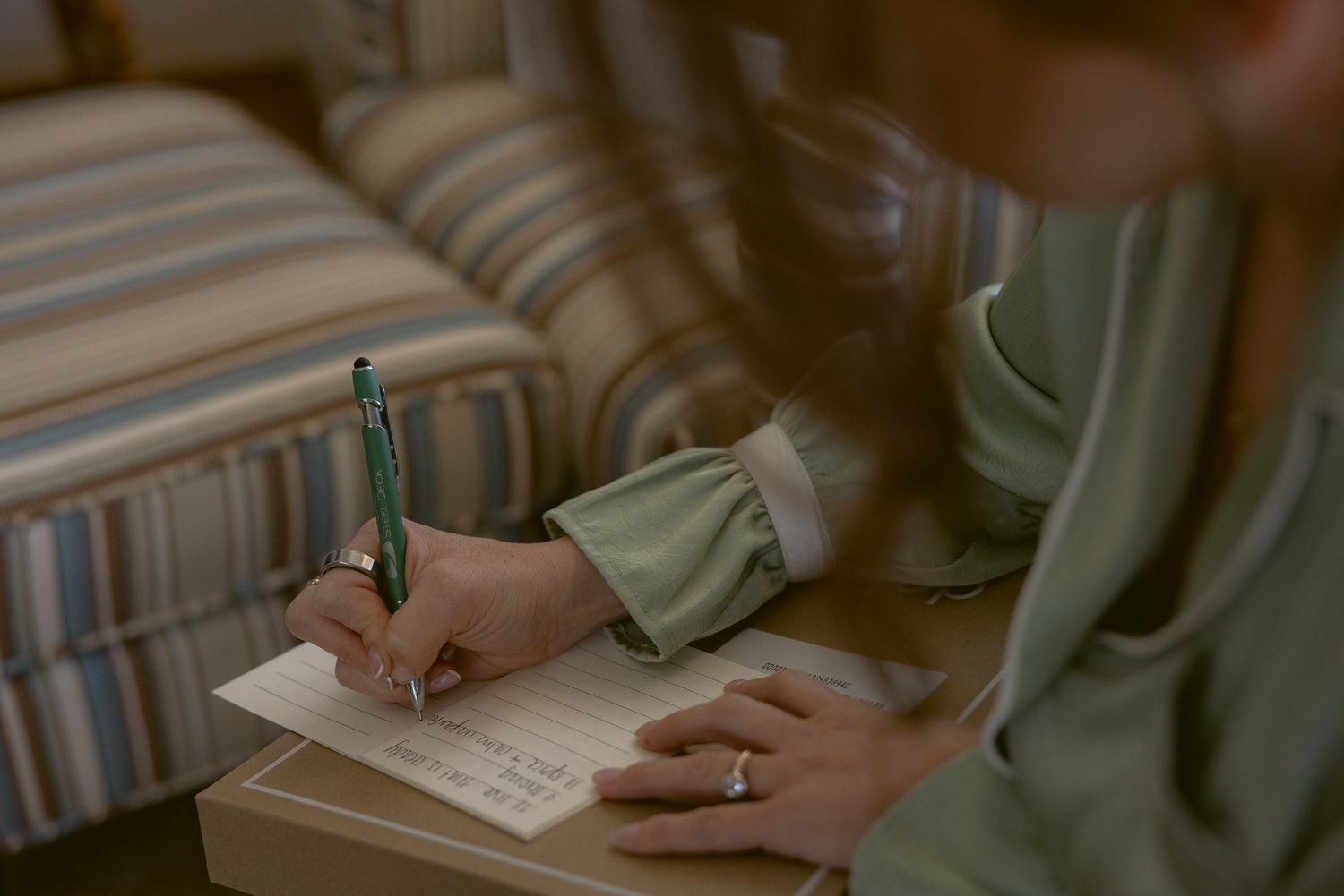 Candid detail of a guest signing the guest book at a Mission Ranch wedding in Carmel, California, by Sammy Aucella Photography