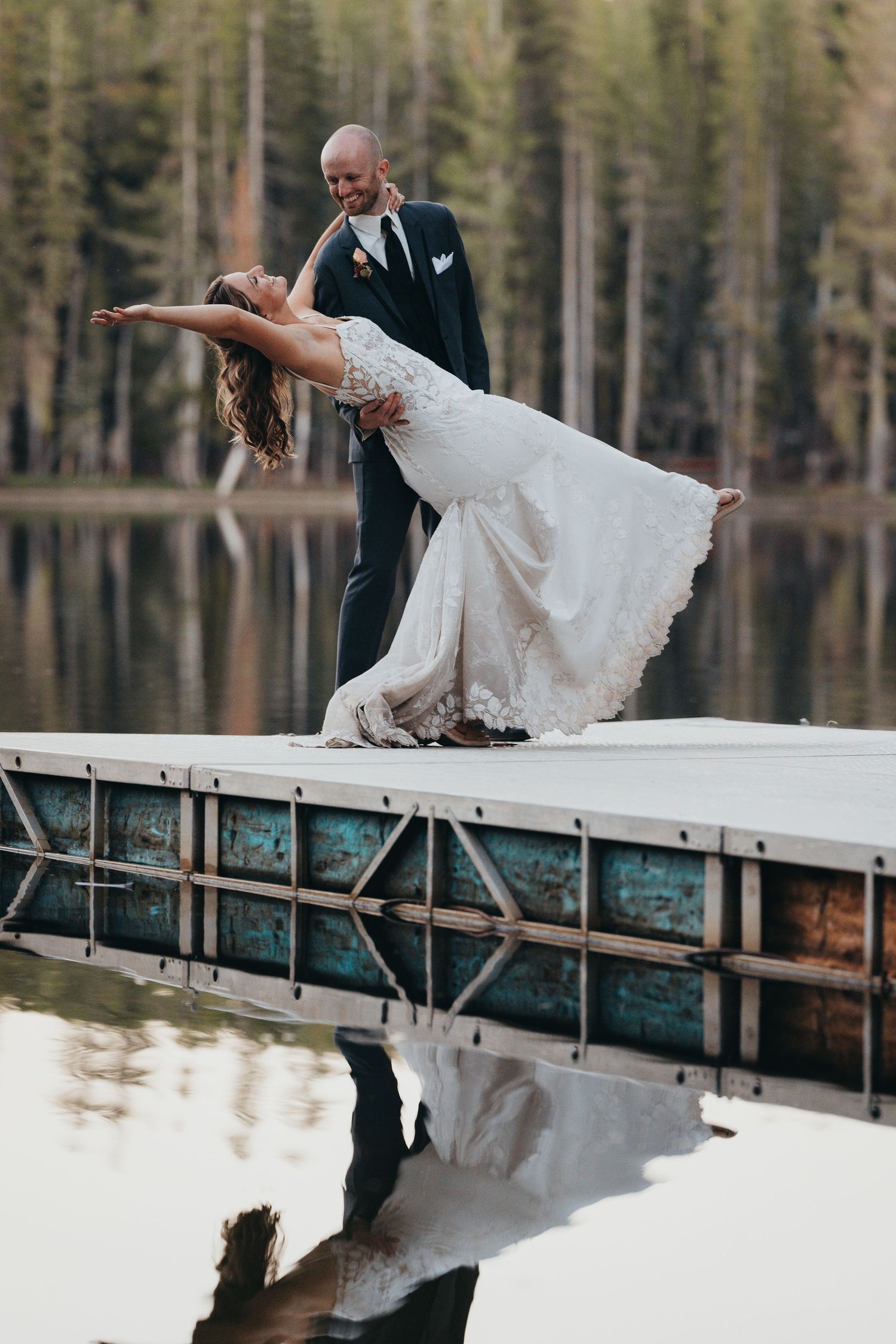 Couple mirrored in still water in a creative reflection, artistic wedding photography