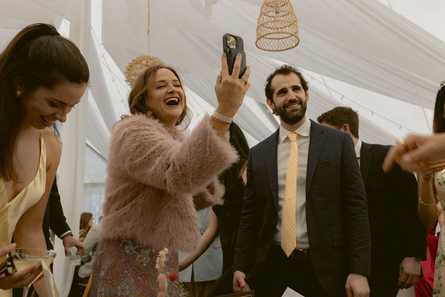 Guests laughing and taking a selfie during a reception at the MacCallum House in Mendocino, California, by Sammy Aucella Photography