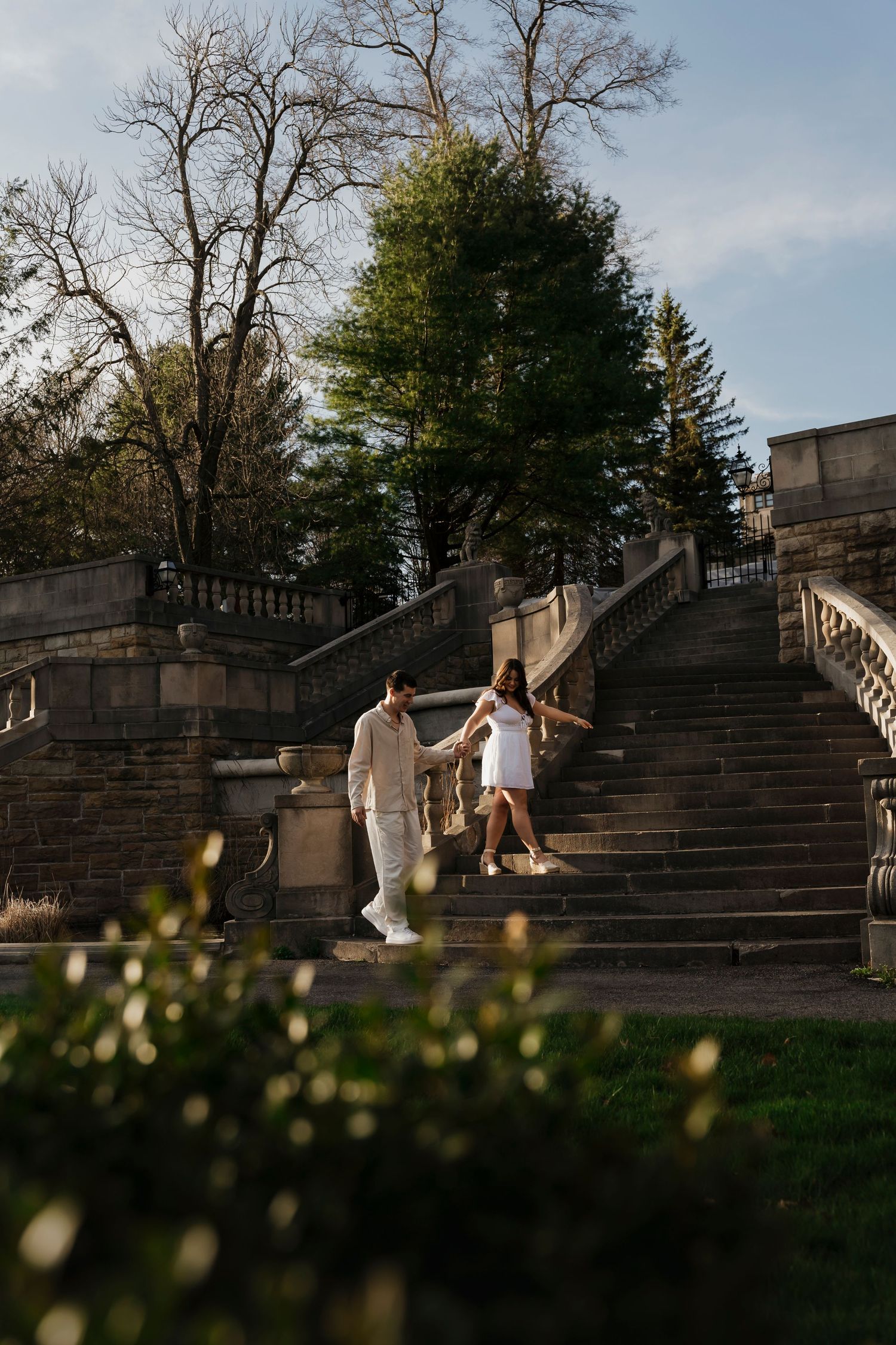 Avalon and Justin holding hands walking through garden paths at their Pennsylvania engagement session