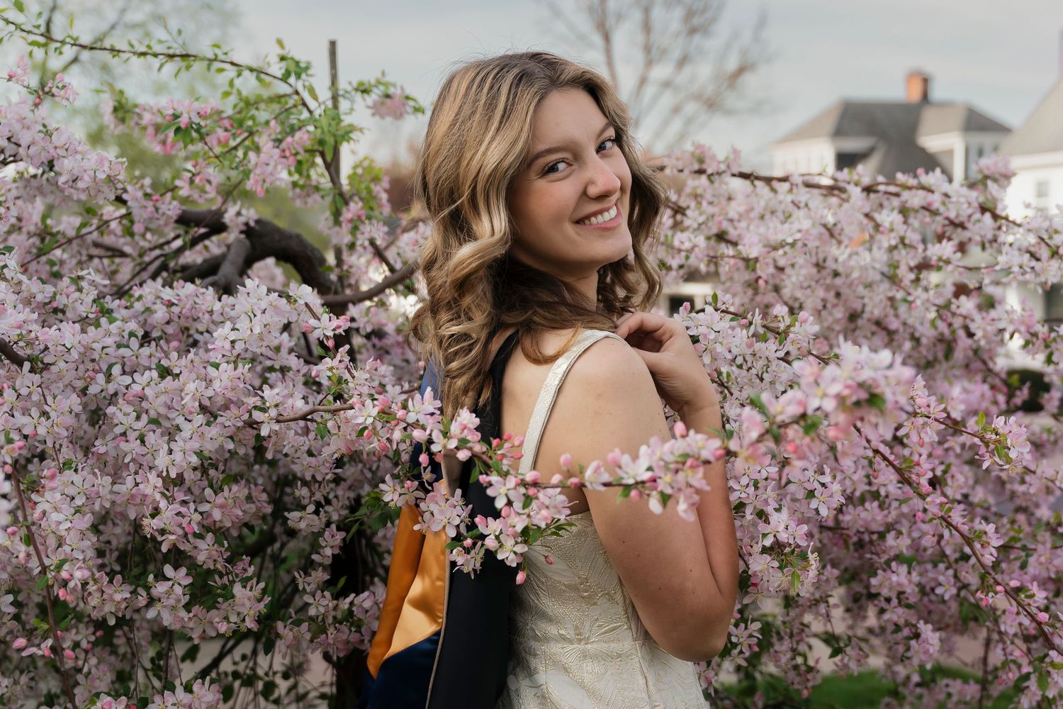 Beautiful spring graduation portraits captured under blooming cherry blossom trees on campus.