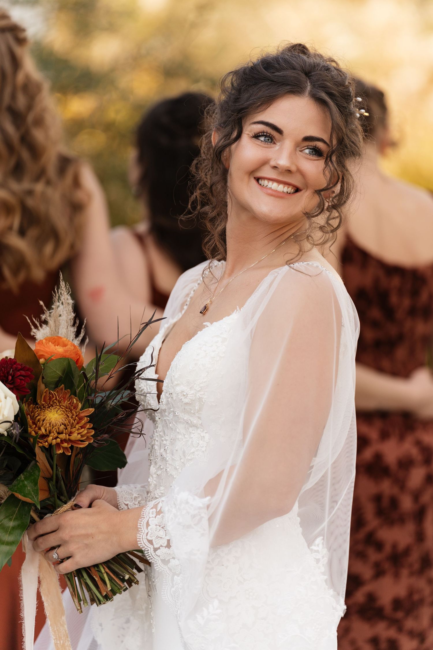 Romantic wedding portraits featuring lace white dress details and autumn-themed floral bouquet.