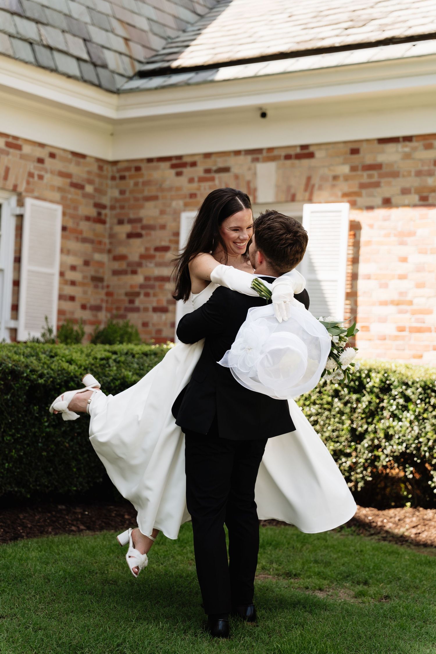 A romantic series of photos showing a couple dancing and spinning together on a lawn in wedding attire.