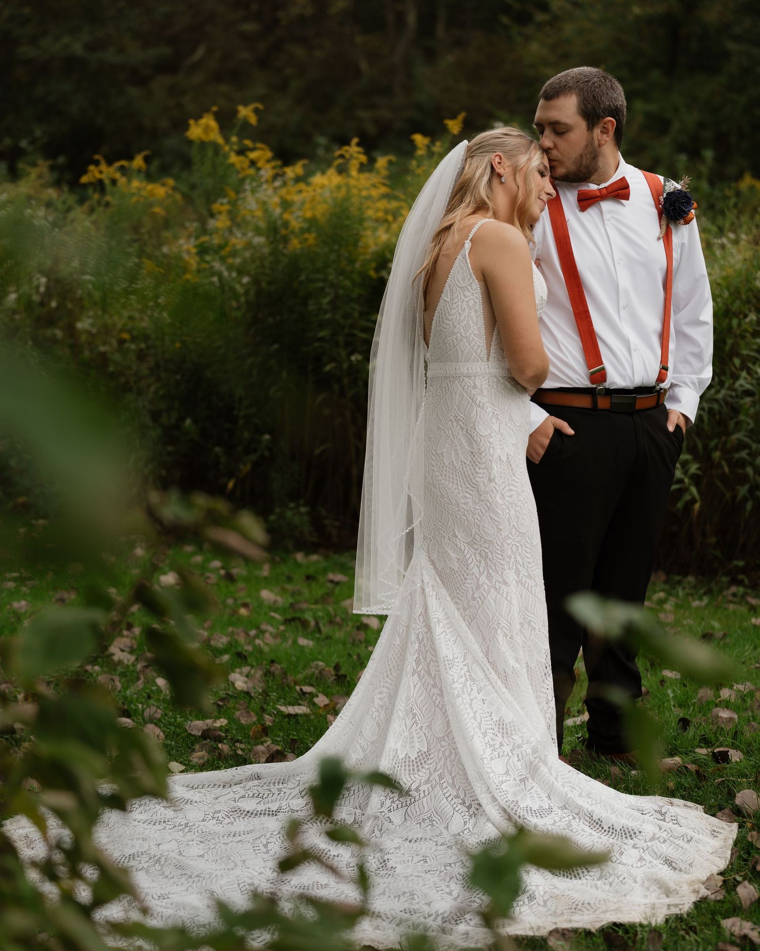 A romantic wedding photoshoot sequence in a natural outdoor setting with lush greenery.
