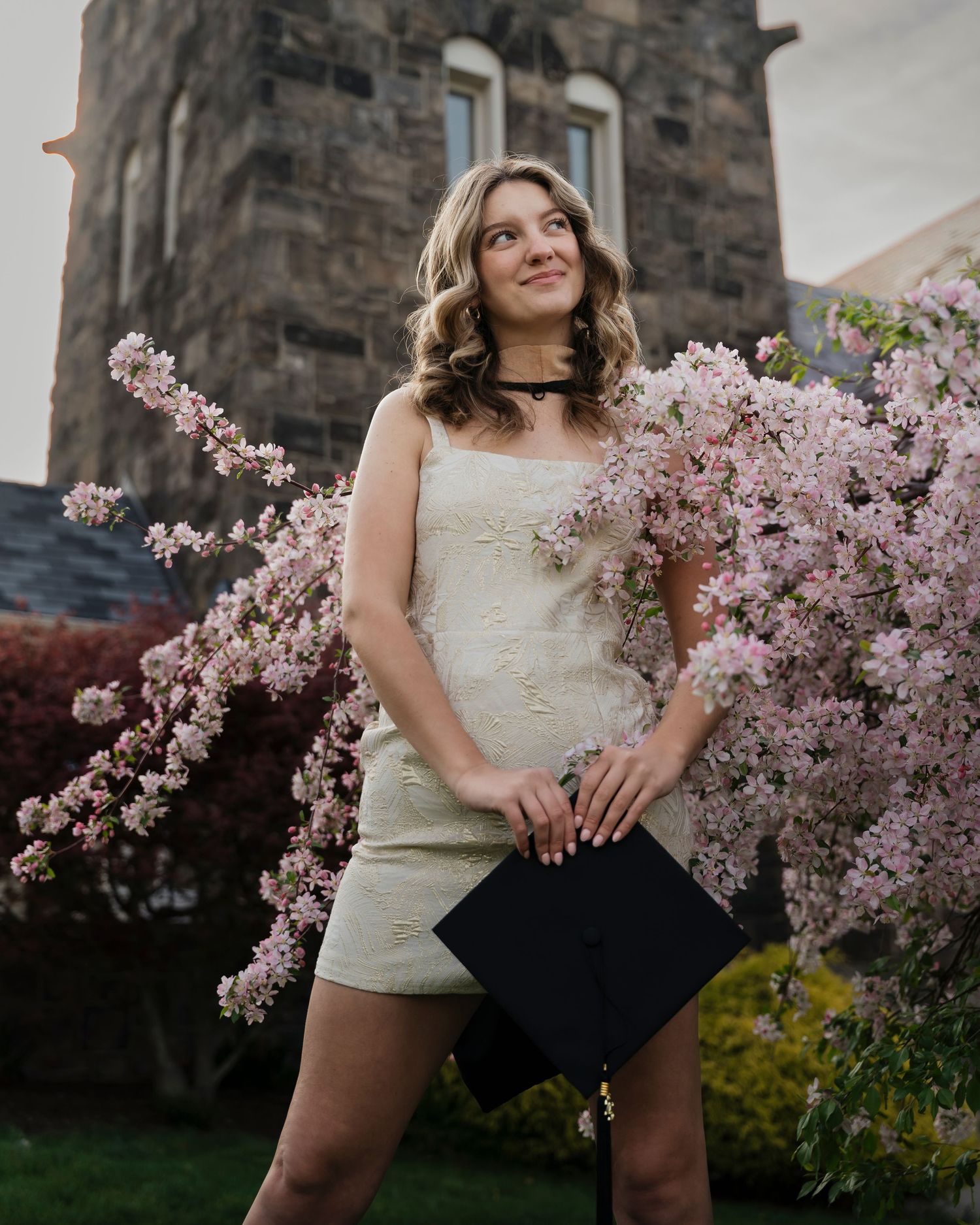 A collection of photos showing a springtime photo shoot among blooming cherry blossoms and stone architecture.