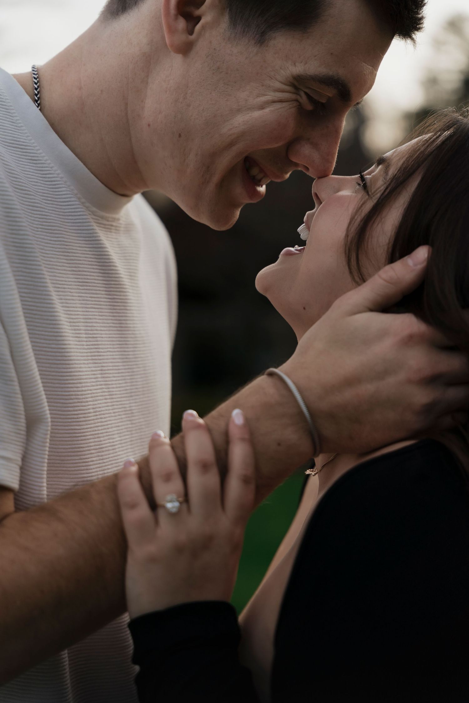 Joyful engaged couple walking through sunlit gardens at Mount Assisi during Pennsylvania engagement session