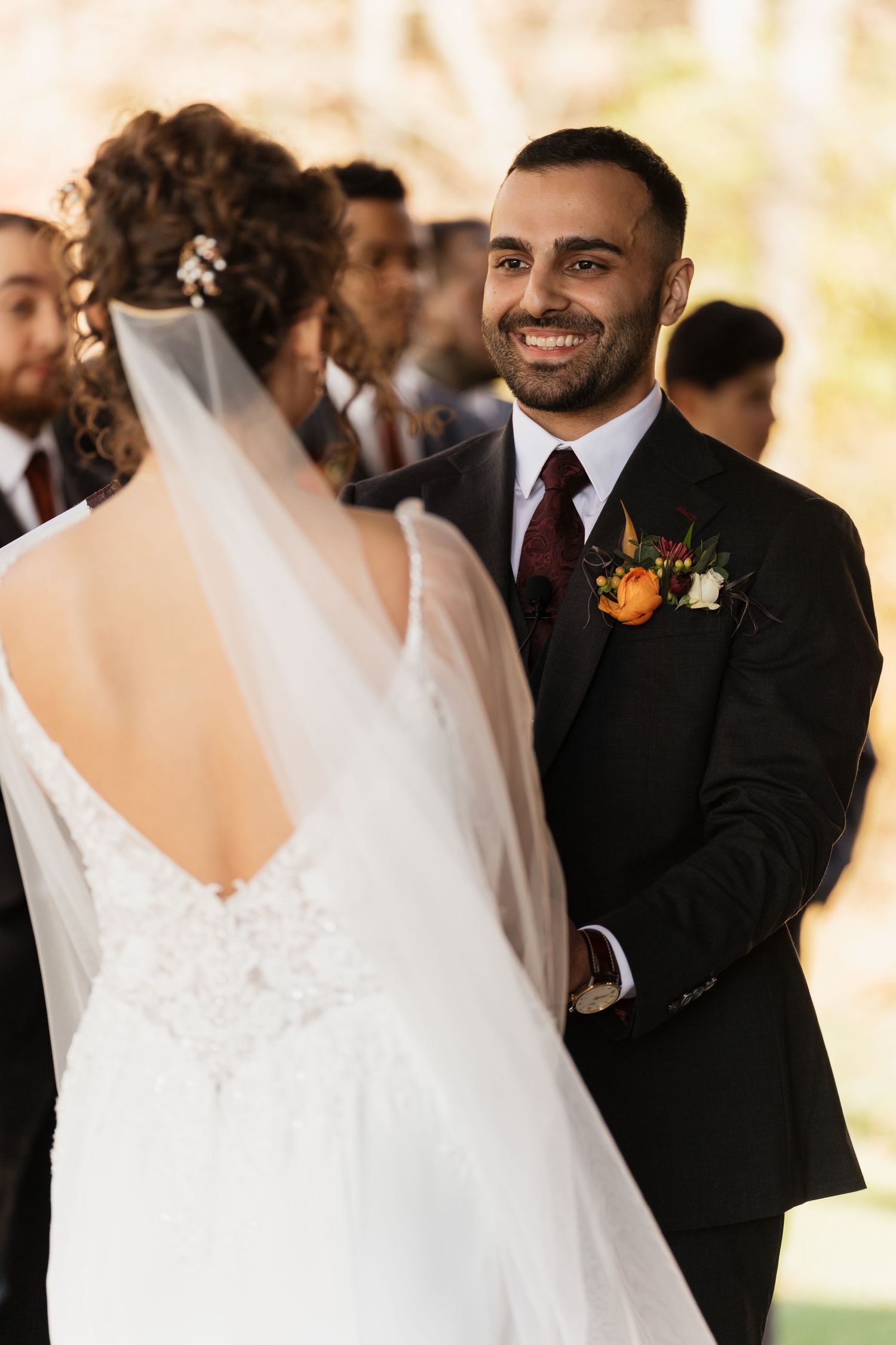 Wedding couple shares intimate moments during outdoor ceremony with warm autumn lighting.