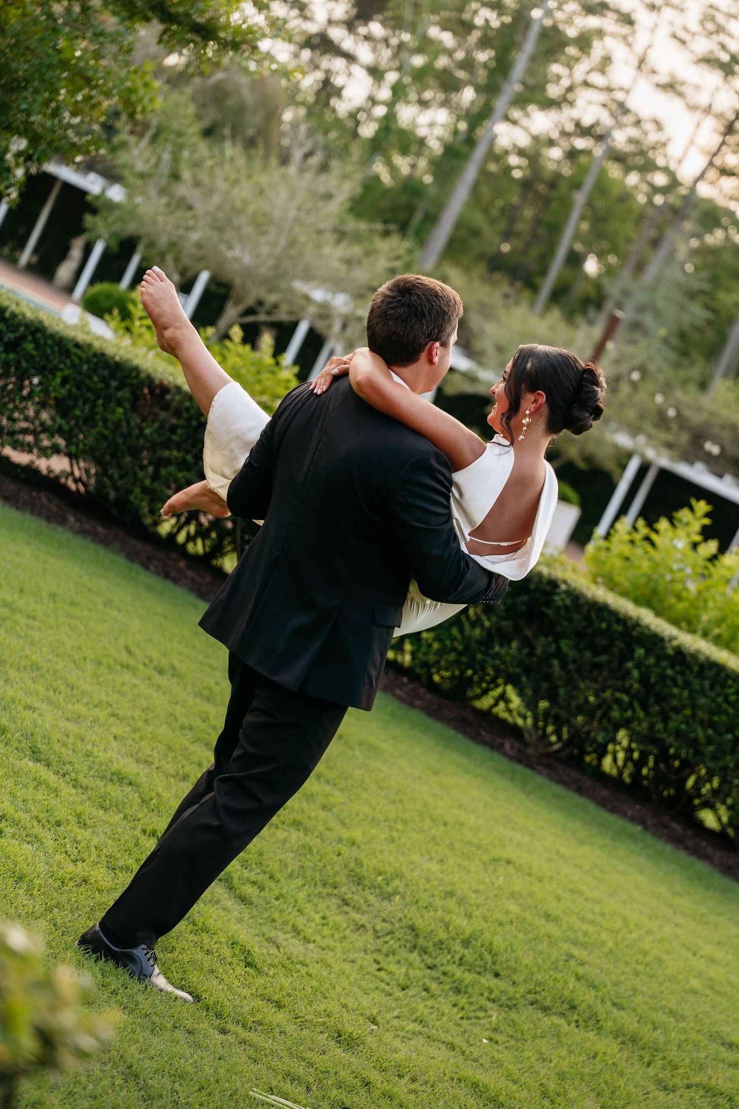 A sequence of dance moves captured in a garden setting shows a person performing spins on a green lawn.