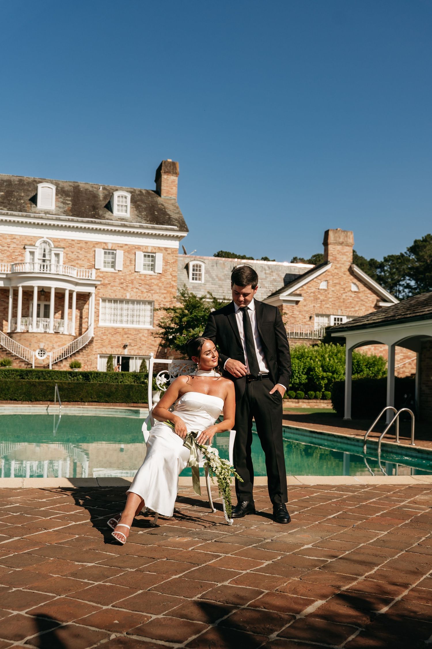 A sequence of playful wedding photos shows a couple sitting by a pool with a brick mansion in the background.