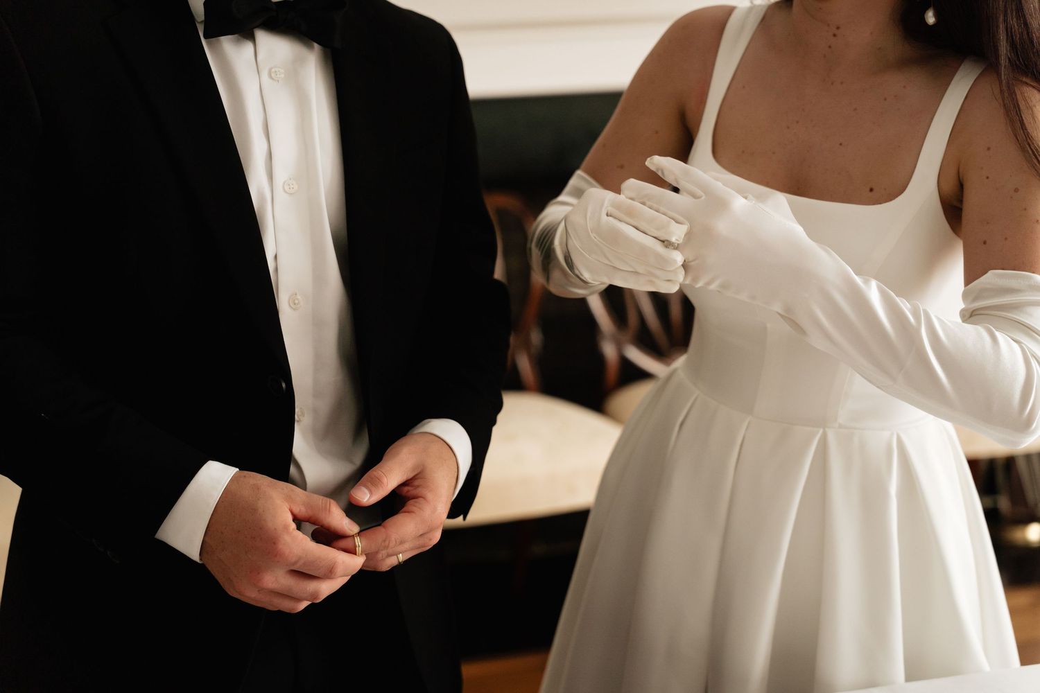 A wedding dress detail showing delicate white fabric with a close-up view of the bodice and waistline.