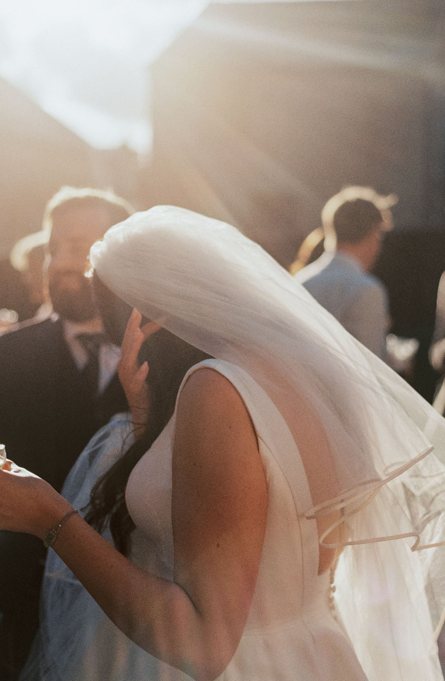 A flowing white wedding veil catches sunlight and movement in a romantic, ethereal sequence of photographs.