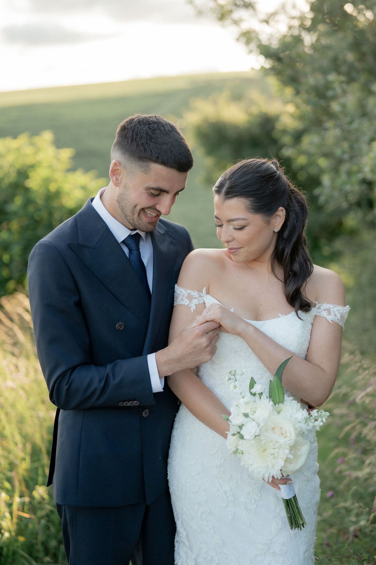 A romantic outdoor wedding photoshoot sequence showing tender moments between newlyweds in a sunlit field.