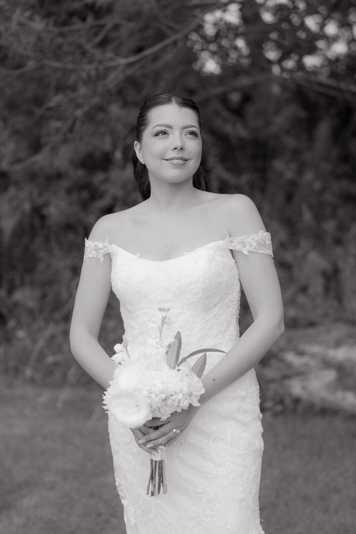Black and white bridal portraits showcasing an elegant off-shoulder wedding gown.
