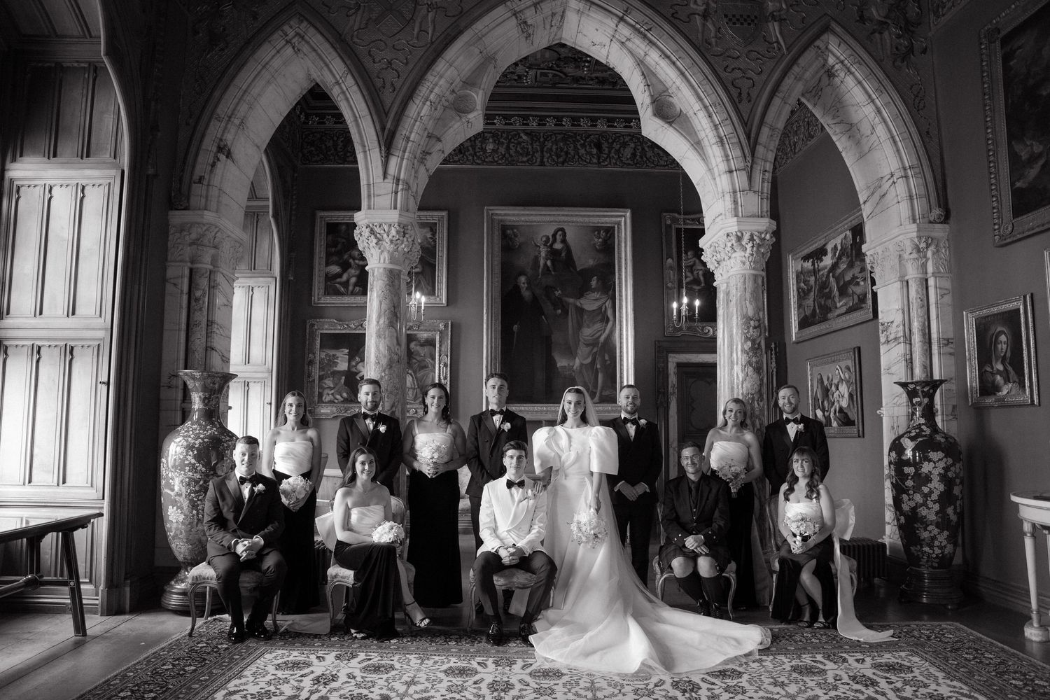 Gothic arched interior of a historic venue with dramatic lighting and architectural details.