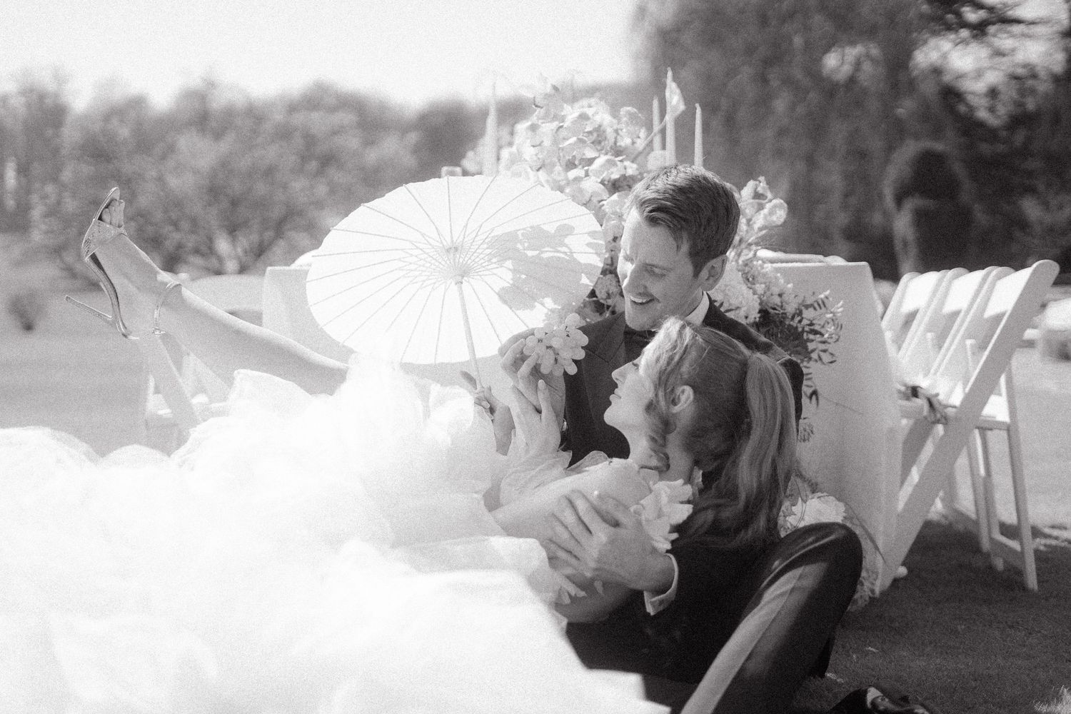A series of black and white wedding celebration moments showing joyful interactions between guests.
