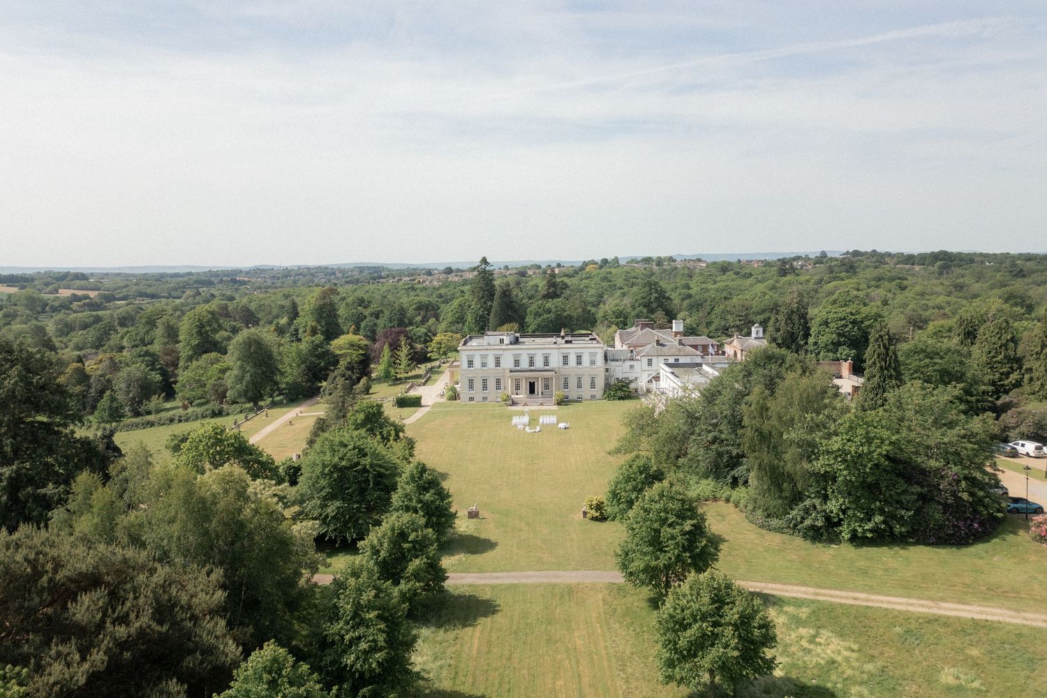 Aerial panorama of Buxted Park estate showing sprawling grounds and architecture.