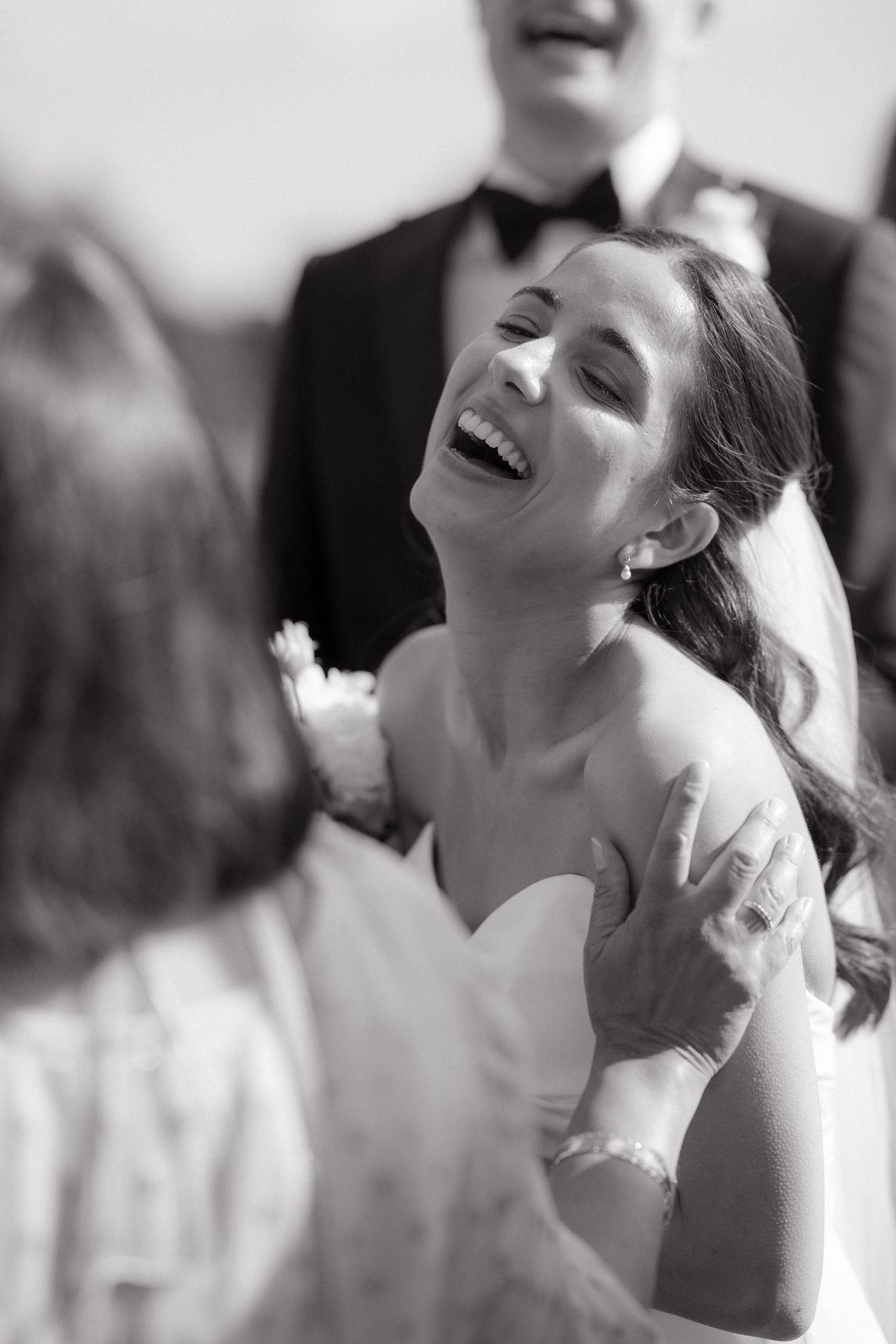 Black and white portrait series showing joyful expressions and laughter in an artistic composition.
