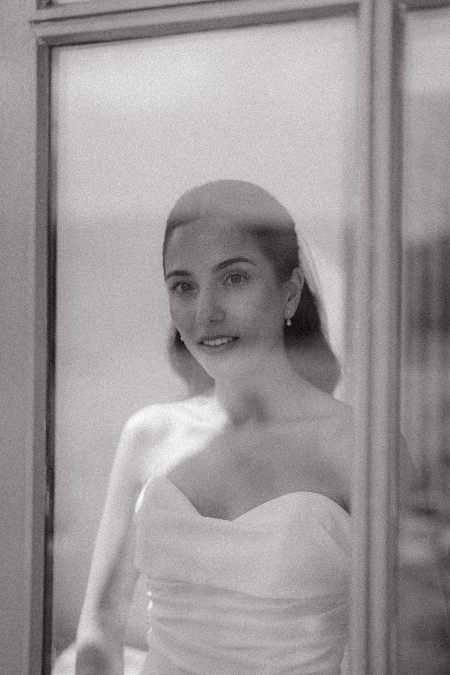 Black and white portrait series of a person wearing white clothing against a light background.