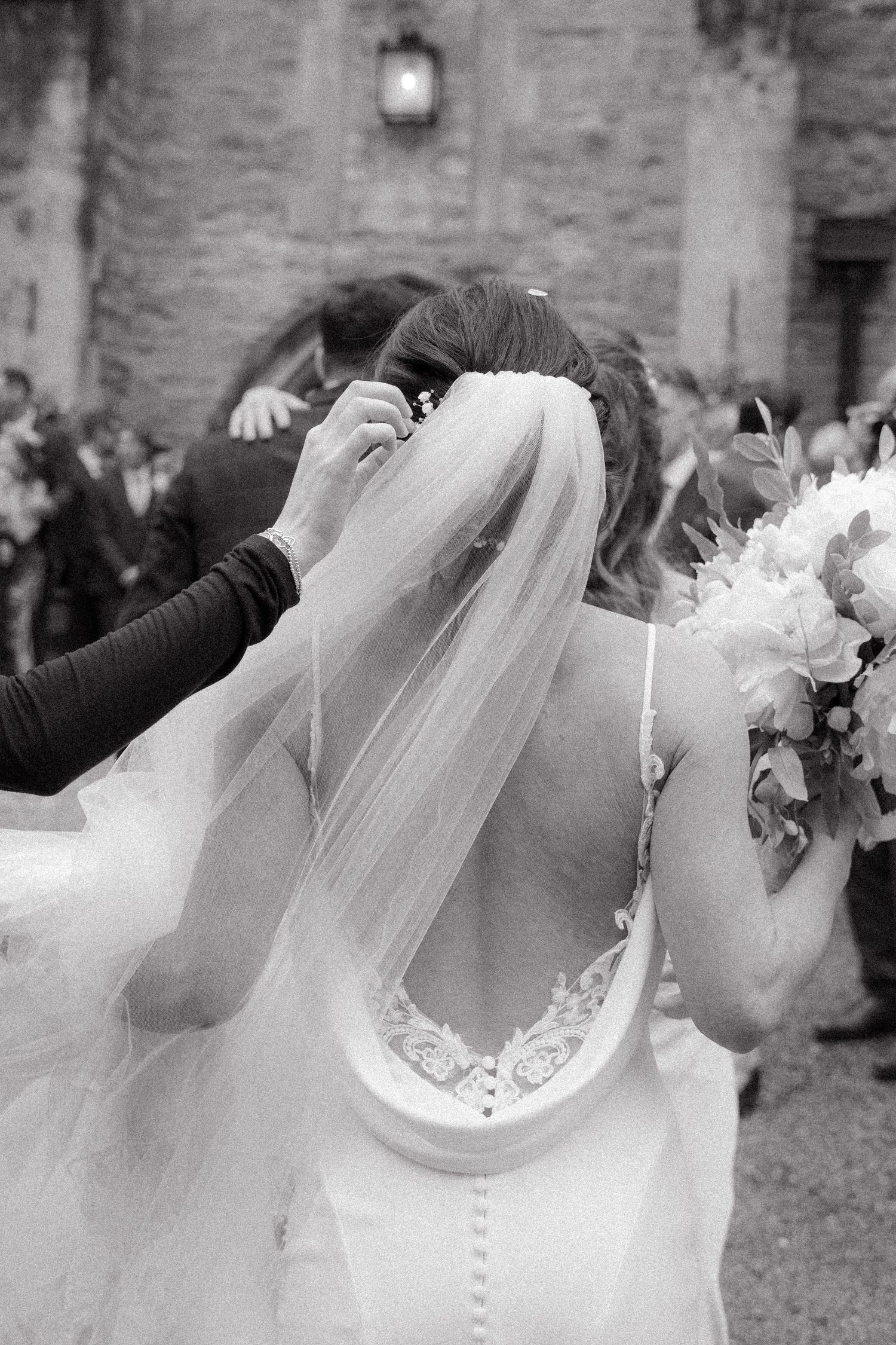 A series of black and white wedding photos showing romantic kisses between newlyweds in traditional wedding attire.