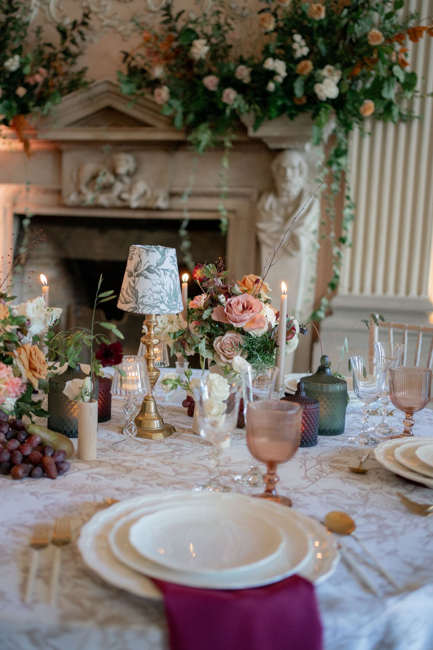 Elegant wedding table setting with floral arrangements, candles, and vintage-inspired decor.