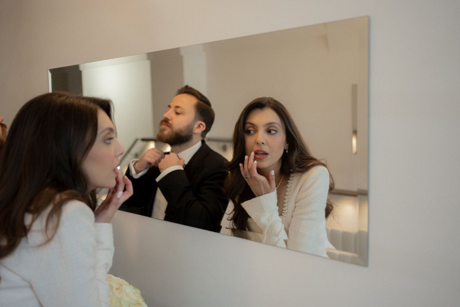 A collage of four images showing people applying makeup in front of mirrors.