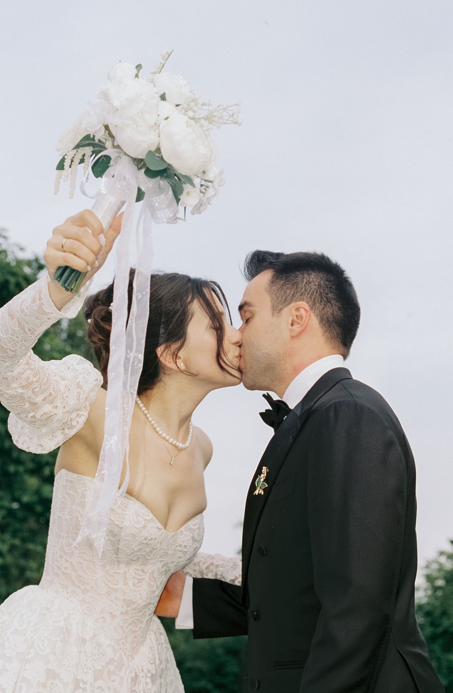 A romantic wedding couple shares intimate moments in a series of elegant outdoor portrait photographs.